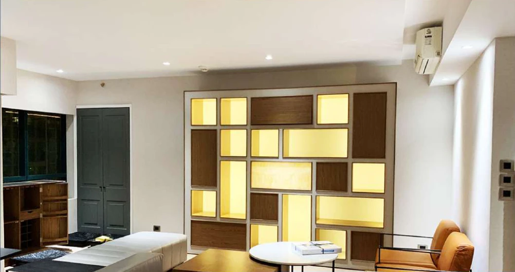 Office lounge interior with illuminated display shelves at Edades Rockwell
